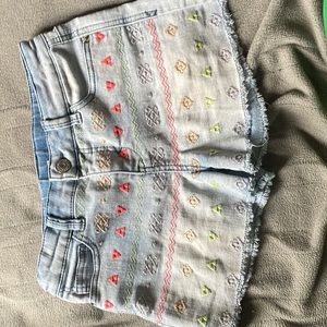 Blue Jean shorts with colorful designs on the front